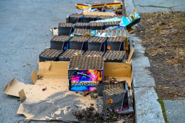 Berlin, Germany - January 1, 2023: Various remains of a New Year's Eve celebration along a street. clipart