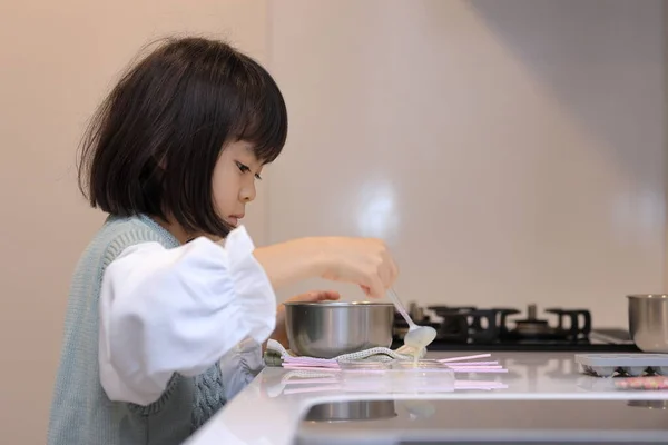 Japanese student girl cooking white chocolate (8 years old)