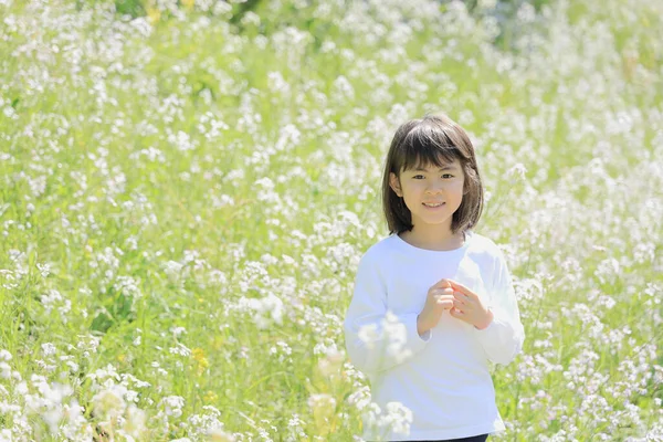 Japanese student girl in flower garden (8 years old)