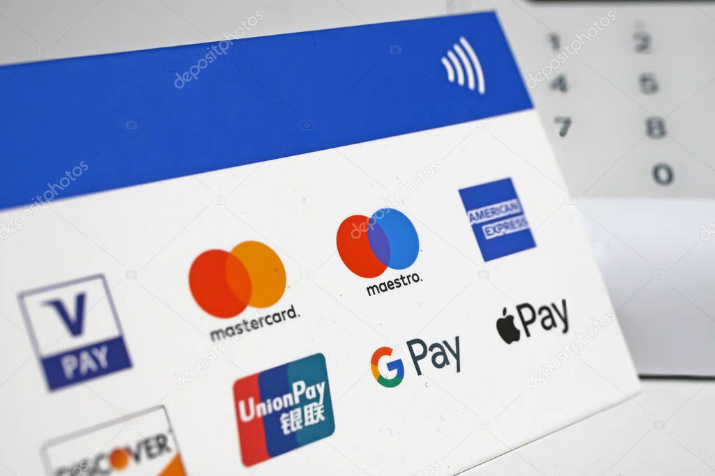 Viersen, Germany - November 9. 2022: Closeup of sign with various contactless payment options, blurred sumup card reader terminal