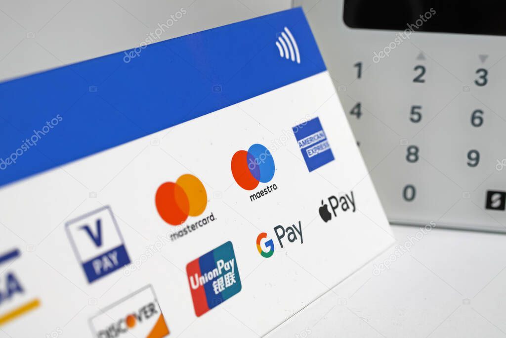 Viersen, Germany - November 9. 2022: Closeup of sign with various contactless payment options, blurred sumup card reader terminal