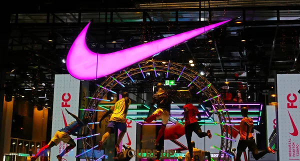 stock image Paris, France - November 29.2022: Closeup of display window of Nike store at night with neon light logo