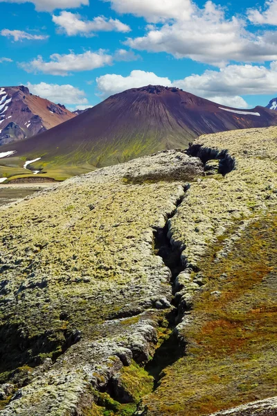 Fissure of the ground leading to cone of black volcano crater cone - Grabrok Grabrokarfell Iceland