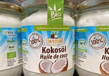Viersen, Germany - January 9. 2023: Closeup of jars 100% dr goerg coconut oil  in shelf of german store