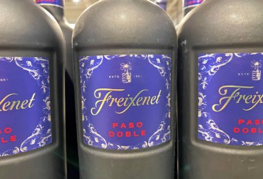Viersen, Germany - January 9. 2023: Closeup of bottles Freixenet paso doble red wine in shelf of german store