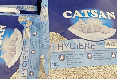Viersen, Germany - January 9. 2023: Closeup of bags Catsan cat litter in shelf of german store