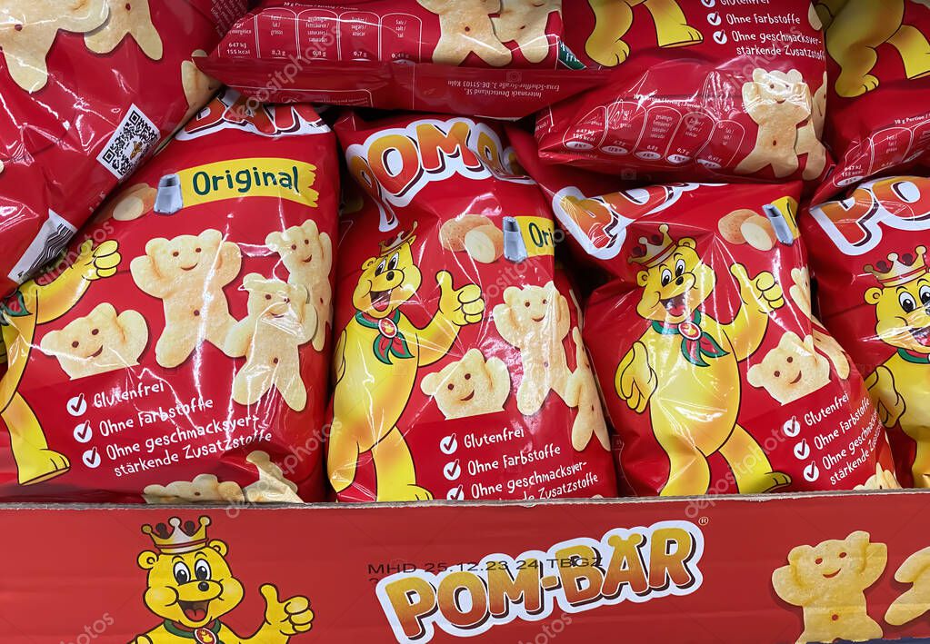 Viersen, Germany - September 9, 2023: Bags Pom-Bear teddy shaped potato chips in shelf of german supermarket