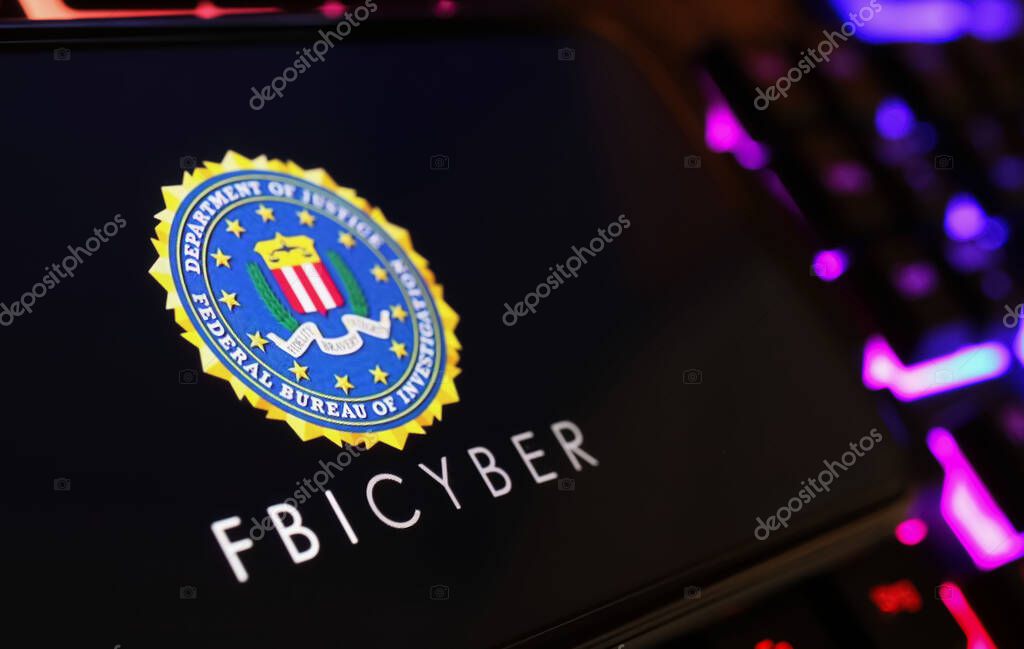 Viersen, Germany - January 9. 2024: Smartphone screen with logo lettering of FBI Cyber on computer keyboard