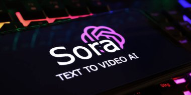 Viersen, Germany - March 1. 2024: Closeup of smartphone screen with logo lettering of Sora text to video AI creator on computer keyboard clipart
