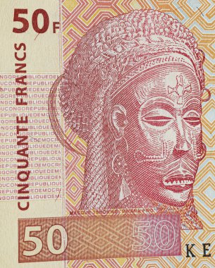 African Chokwe tribe female Pwevo, Mwana Pwo ritual mask on congolese 50 Francs currency banknote (focus on center) clipart