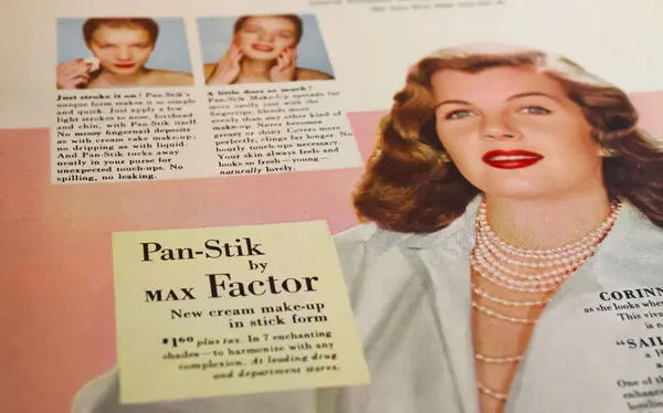 stock image Viersen, Germany - May 1. 2024: Closeup of vintage magazine page with Max Factor Pan-Stick make-up cream advertising from 1952 (focus on center)