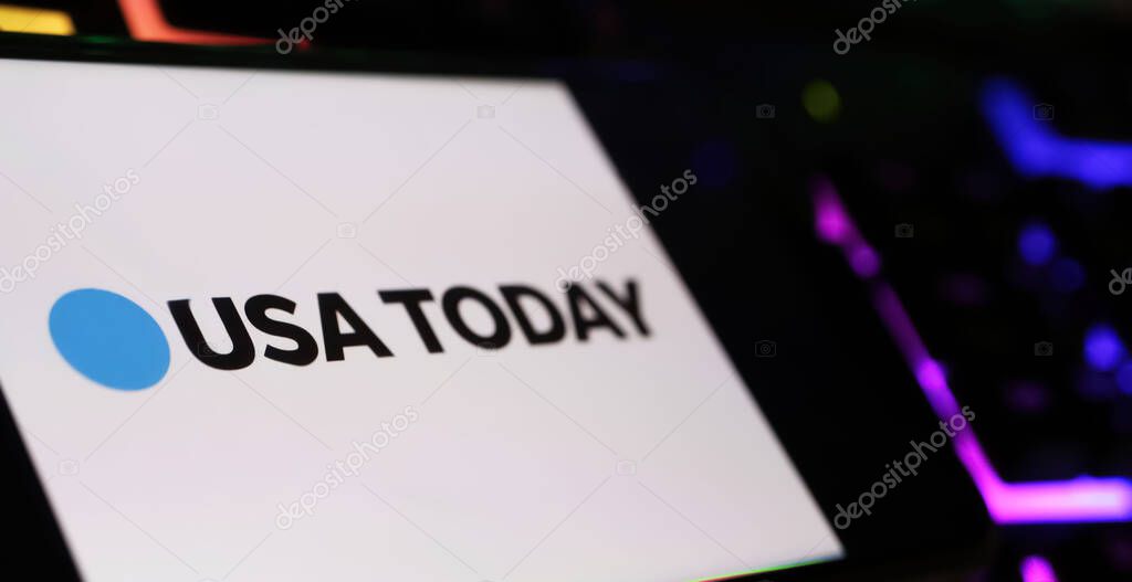 Viersen, Germany - May 1. 2024: Closeup of smartphone with logo lettering of digital newspaper USA Today on computer keyboard