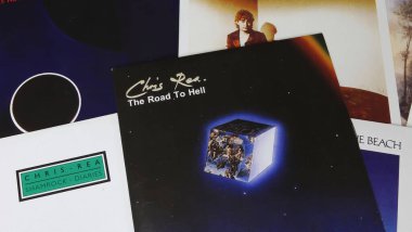 Viersen, Germany - May 9. 2024: Closeup of british singer Chris Rea music album covers with Road to Hell from 1989 in center clipart