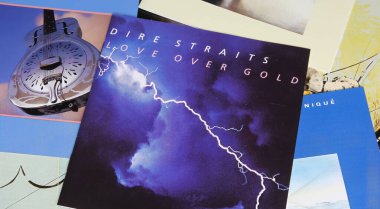 Viersen, Germany - May 9. 2024: Closeup of british rock band Dire Straits record album covers with Love over Gold in center clipart
