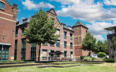 Kempen (NRW), Germany - June 9. 2024: Modernized old listed factory building with use as offices and city administration clipart