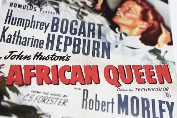 stock image Viersen, Germany - May 9. 2024: Detail of official African Queen cinema film poster with Katharine Hepburn and Humphrey Bogart from 1951 (focus on center)