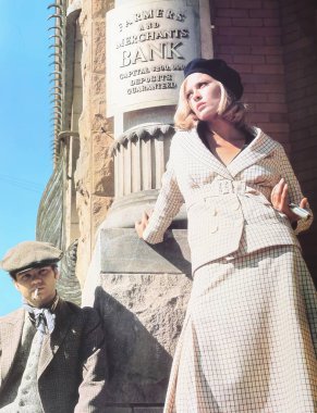 Viersen, Germany - May 9. 2024: Bonnie and Clyde film scene detail with Faye Dunaway waiting in front of bank from 1967 (focus on center) clipart