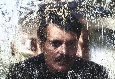 Viersen, Germany - May 9. 2024:  Doctor Zhivago film cinema scene detail with Omar Sharif through iced window from 1965 in old magazine (focus on center) clipart