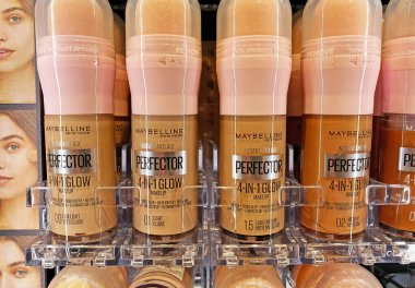 Viersen, Germany - December 8. 2024: Closeup of Maybelline Perfector anti age 4 in 1 glow makup in german store (focus on central bottles) clipart