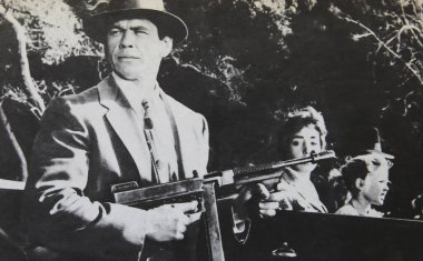 Viersen, Germany - July 8. 2024: Old magazine photo of Charles Bronson in gangster film noir Machine Gun Kelly from 1958 (focus on left person) clipart