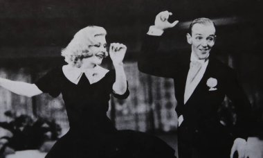 Viersen, Germany - June 2. 2024: Old magazine photo of Fred Astaire dancing and singing with Ginger Rogers in Swing Time from 1936 (focus on persons) clipart