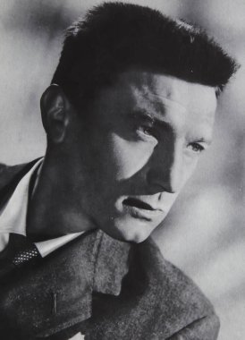 Viersen, Germany - June 2. 2024: Old magazine portrait photo of british actor Laurence Harvey from 1950s (focus on face) clipart