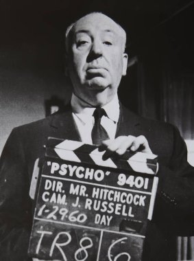 Viersen, Germany - June 2. 2024: Old magazine photo of Alfred Hitchcock with Psycho film scene director clipboard from 1960 (focus on face) clipart