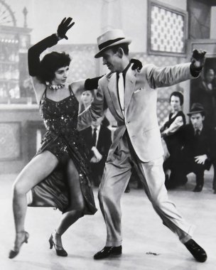 Viersen, Germany - June 3. 2024: Old magazine photo of Cyd Charisse and Fred Astaire dancing in musical The Band Wagon from 1953 (focus on persons in front) clipart