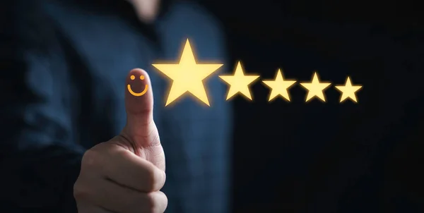 Thumb up with glowing yellow five stars for excellent evaluate after customer use product service , ISO and quality standard certificate concept.