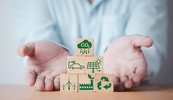 stock image Businessman giving CO2 reducing ,Recycle ,Green factory icon for decrease CO2 , carbon footprint and carbon credit to limit global warming from climate change, Bio Circular Green Economy concept.