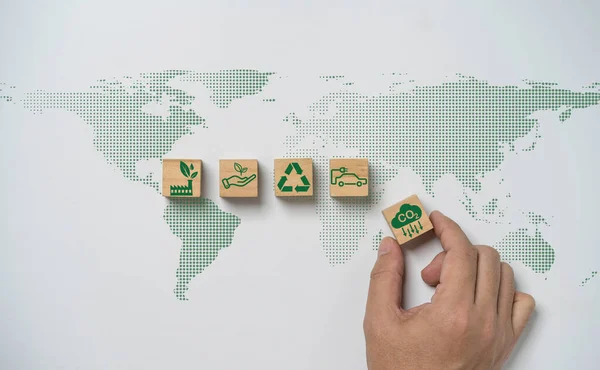 Hand array CO2 reducing ,Recycle ,Green factory icon on world map for decrease CO2 , carbon footprint and carbon credit to limit global warming from climate change, Bio Circular Green Economy concept.