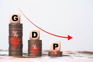 GDP or Gross Domestic Product wording on decreasing coins stacking and red down arrow for economic recession concept.