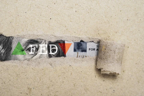 Torn brown paper with FED wording and  up down arrow on USD dollar banknote for Federal reserve increase and decrease interest rate control which effect to America and world economic growth concept.