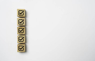 Onaylama belgesi ve proje konsepti için beyaz kopya alanı arkaplanı olan tahta blok küpündeki doğru işaret sembolü.