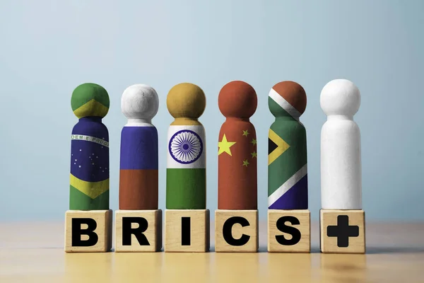 Brazil Russia India China and South Africa flag print screen on wooden figure with plus sign for many countries need to participate to BRICS economic international cooperation concept.