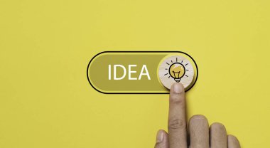 Hand touching to toggle button with glowing lightbulb icon to open idea status for creative thinking idea innovation and problem solving solution concept. clipart