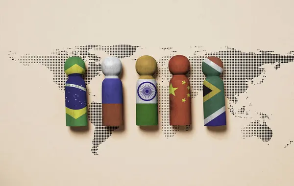 Brazil Russia India China and South Africa flag print screen on wooden figure with world map for BRICS economic international cooperation concept.
