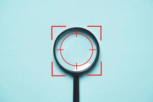 Focus icon inside of magnifier glass for concentrate with business objective goal and target on blue background and copy space.