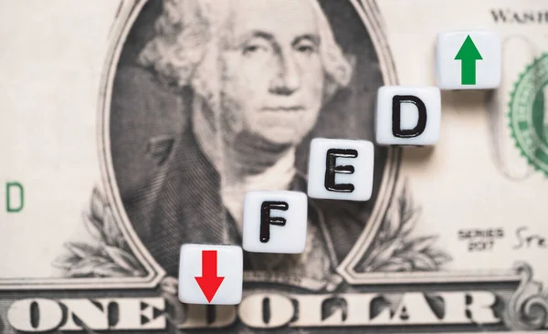 FED wording with up and down arrow on USD dollar banknote for Federal reserve increase and decrease interest rate control which effect to America and world economic growth concept.