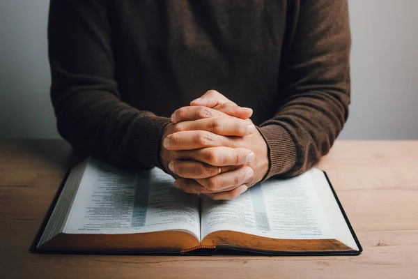 stock image Man praying over the open bible. faith and believe concept