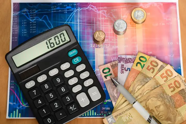 Stock image Brazilian money and a calculator on a financial graph