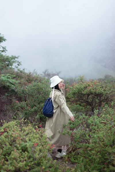 stock image Young girl with backpack enjoying travel nature at kawah ijen. The back view of the girl who is travel kawah ijen In the summer, Travel relax, Travel Indonesia.