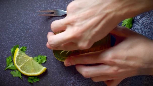 Hands Opening Can Sardines Tomato Sauce Dark Blue Table Lemon — Video Stock