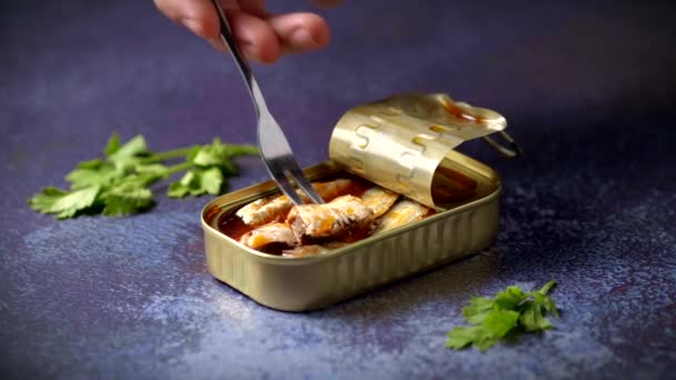 Hand Fork Picking Canned Sardines Tomato Sauce Dark Blue Table — Αρχείο Βίντεο