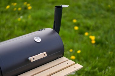 New smoker barbecue grill. Equipment for cooking and smoking. Closeup.