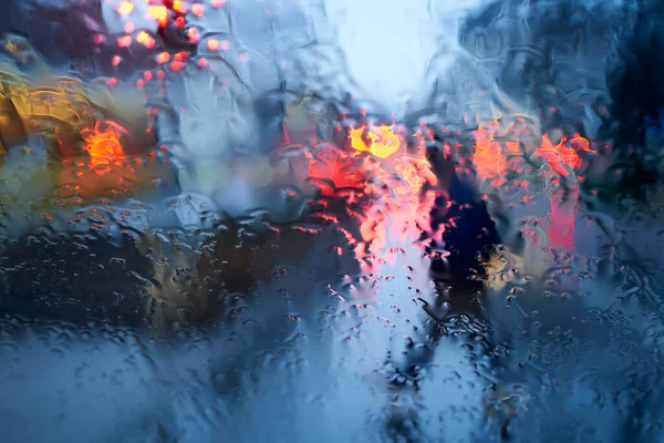 stock image Raindrops on the windshield. Rush hour traffic in the city. Pedestrian.