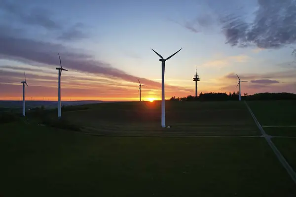 Wind energy as sustainable and renewable resource. Wind turbines for the production of bio power. Sunrise in germany. Aerial view with drone.