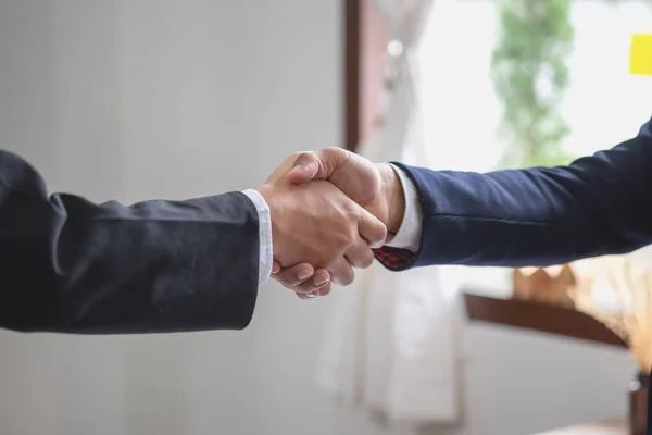 stock image two business men shake hands for business cooperation