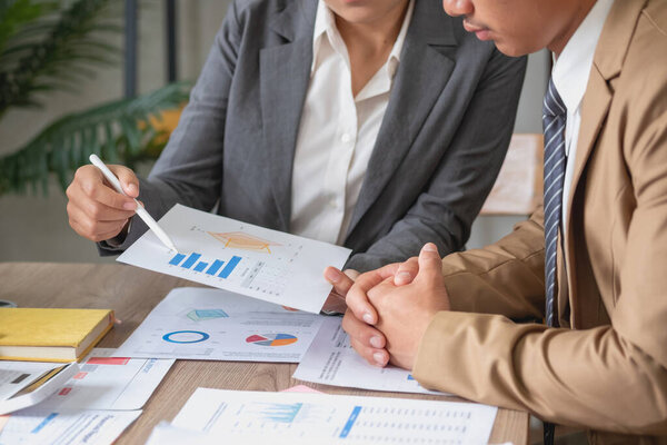 Marketing, Finance, Accounting, Planning, A team of businessmen plan with their laptops and graph charts for their profits and use a calculator to calculate their company is annual balance.