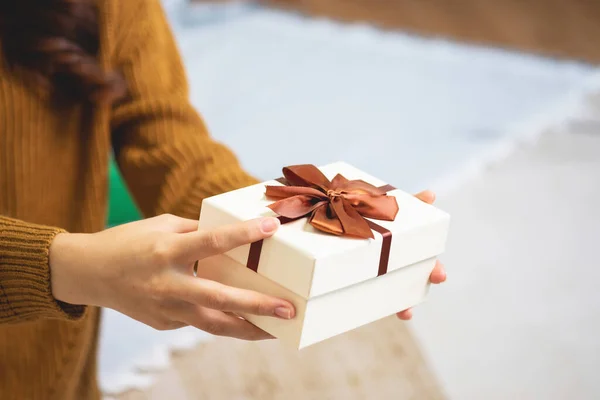 Stock image Merry Christmas and Happy Holidays! Young woman with a beautiful face in a yellow shirt shows joy with gift boxes in a house with a Christmas tree decorated with Christmas tree.  Portrait before Xmas